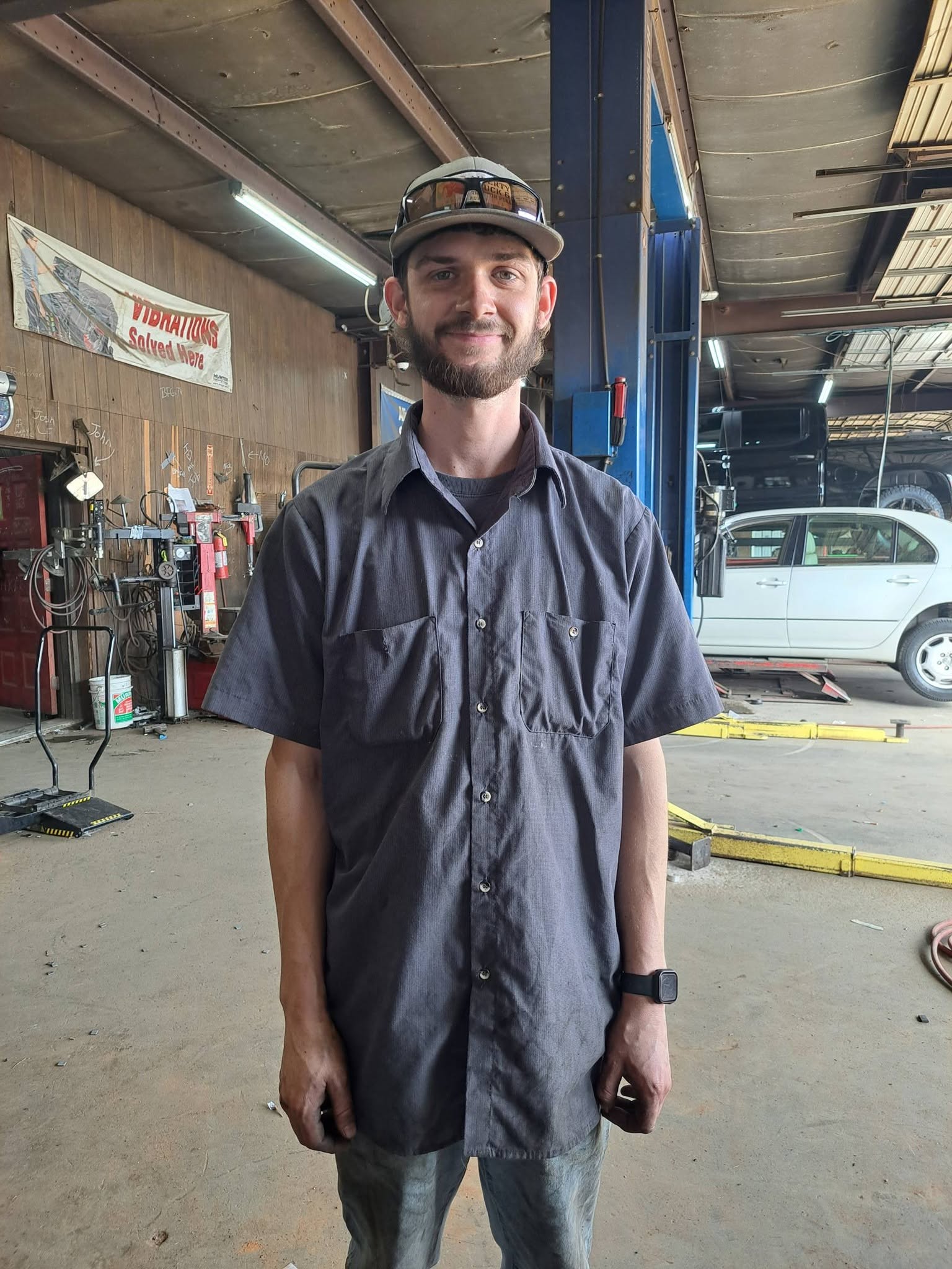 A Madison Car Care technician standing in the service shop